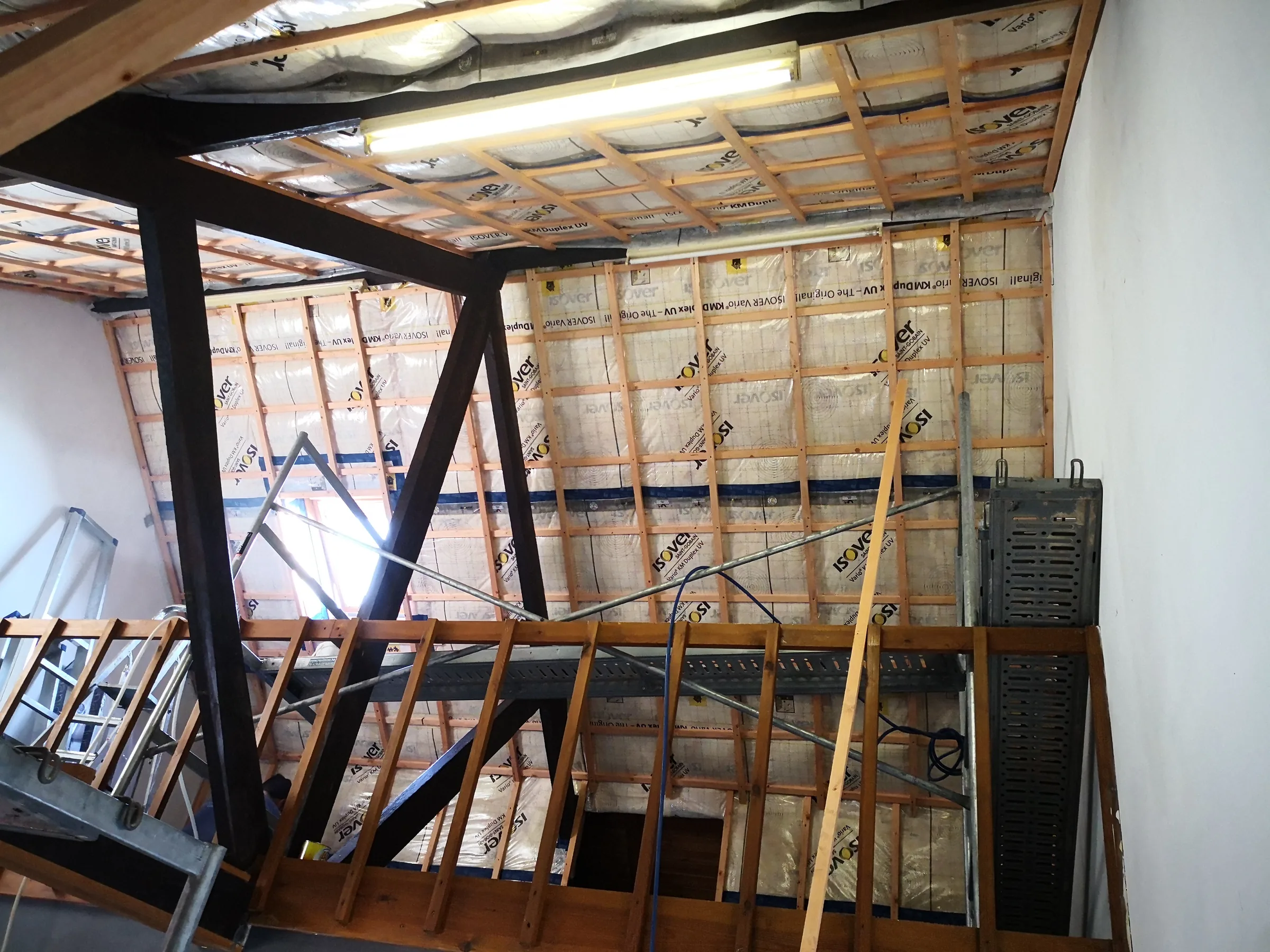 Isolation sous toiture avec membrane frein-vapeur et lattage, vue depuis une cage d'escalier