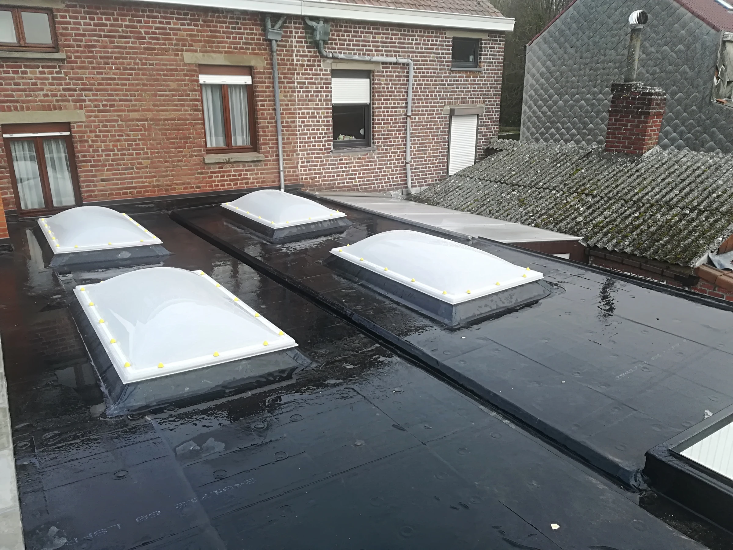 Toiture plate terminée avec quatre coupoles d'éclairage